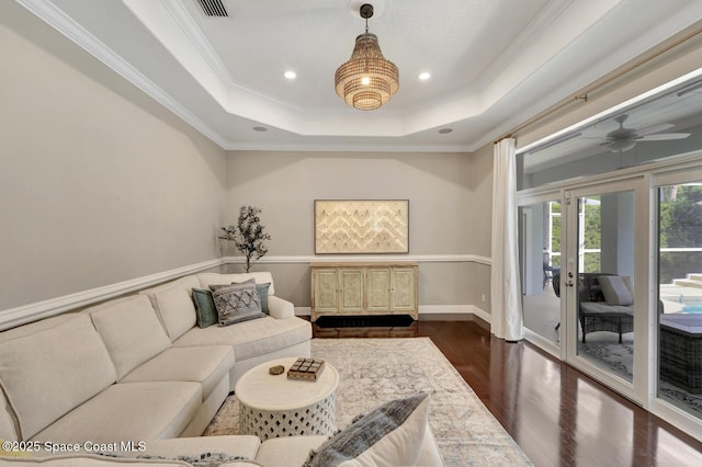 105 38th Ct, Vero Beach, FL 32968 - living room featuring a raised ceiling, dark wood-type flooring, recessed lighting, ceiling fan, and ornamental molding