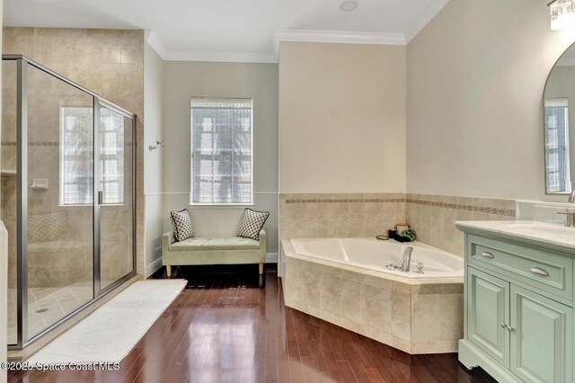 105 38th Ct, Vero Beach, FL 32968 - full bathroom with a bath, vanity, wood finished floors, a stall shower, and crown molding