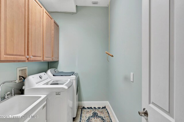 105 38th Ct, Vero Beach, FL 32968 - laundry area featuring cabinet space, washing machine and dryer, baseboards, and tile patterned flooring