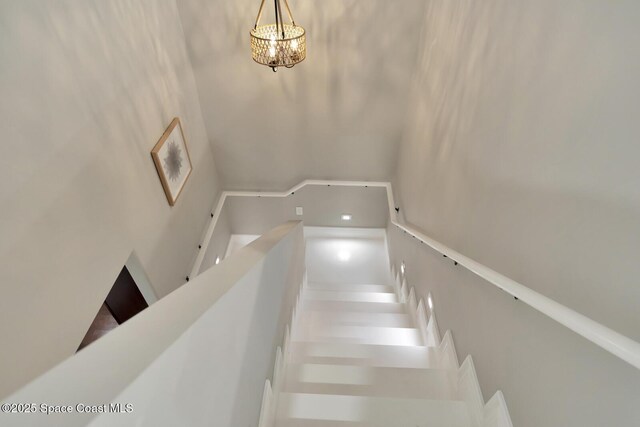 105 38th Ct, Vero Beach, FL 32968 - stairs with a chandelier
