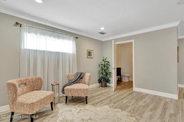 105 38th Ct, Vero Beach, FL 32968 - living area with light wood-style flooring, ornamental molding, recessed lighting, baseboards, and a textured ceiling