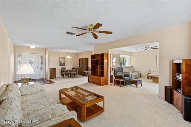 1181 Fairway Ct NE, Palm Bay, FL 32905 - living area featuring light colored carpet, ceiling fan, and a textured ceiling