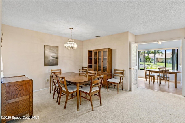 1181 Fairway Ct NE, Palm Bay, FL 32905 - dining room with a chandelier, carpet, a textured ceiling, and baseboards