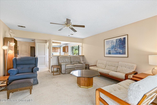1181 Fairway Ct NE, Palm Bay, FL 32905 - living room with carpet flooring, ceiling fan, and a textured ceiling