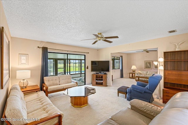 1181 Fairway Ct NE, Palm Bay, FL 32905 - carpeted living area with a ceiling fan and a textured ceiling