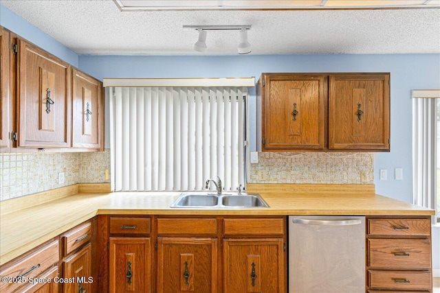 1181 Fairway Ct NE, Palm Bay, FL 32905 - kitchen with dishwasher, a sink, track lighting, light countertops, and tasteful backsplash