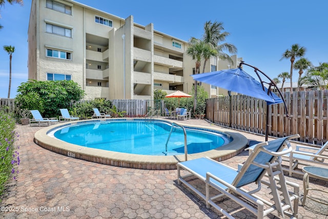 5050 Ocean Beach Blvd Unit 309, Cocoa Beach, FL 32931 - community pool featuring a patio