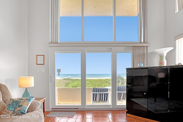 5050 Ocean Beach Blvd Unit 309, Cocoa Beach, FL 32931 - tiled living area with a towering ceiling and a water view