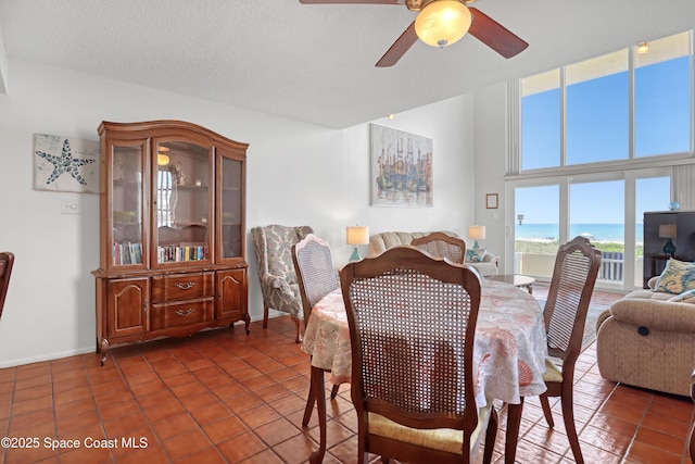 5050 Ocean Beach Blvd Unit 309, Cocoa Beach, FL 32931 - dining room with ceiling fan, dark tile patterned flooring, and baseboards