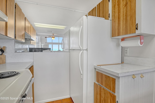 5050 Ocean Beach Blvd Unit 309, Cocoa Beach, FL 32931 - kitchen with under cabinet range hood, white appliances, ceiling fan, and light countertops