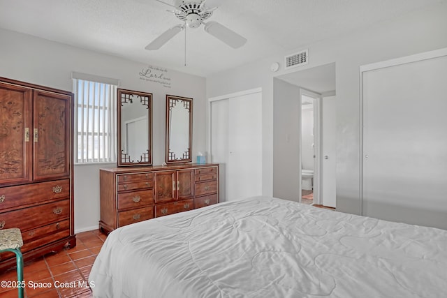 5050 Ocean Beach Blvd Unit 309, Cocoa Beach, FL 32931 - tiled bedroom with two closets and ceiling fan