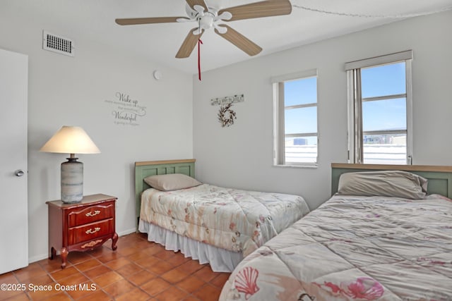 5050 Ocean Beach Blvd Unit 309, Cocoa Beach, FL 32931 - tiled bedroom with multiple windows and ceiling fan