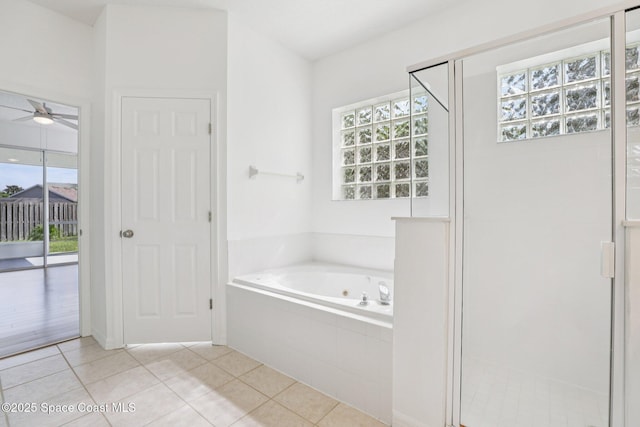 1609 Kestrel Ct, Rockledge, FL 32955 - full bathroom featuring a whirlpool tub, ceiling fan, a stall shower, and tile patterned floors
