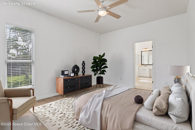 1609 Kestrel Ct, Rockledge, FL 32955 - bedroom with connected bathroom, baseboards, light wood-style flooring, and ceiling fan