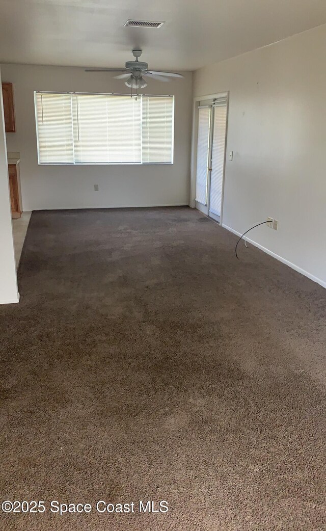 1241 Cambo Ct NE, Palm Bay, FL 32905 - spare room with a ceiling fan, carpet floors, and baseboards