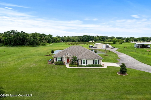 6435 Dixie Way, Mims, FL 32754 - view of front of house with an outdoor structure, stone siding, driveway, and view of scattered trees