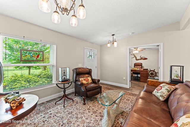 6435 Dixie Way, Mims, FL 32754 - living area with a chandelier, wood finished floors, baseboards, and a textured ceiling
