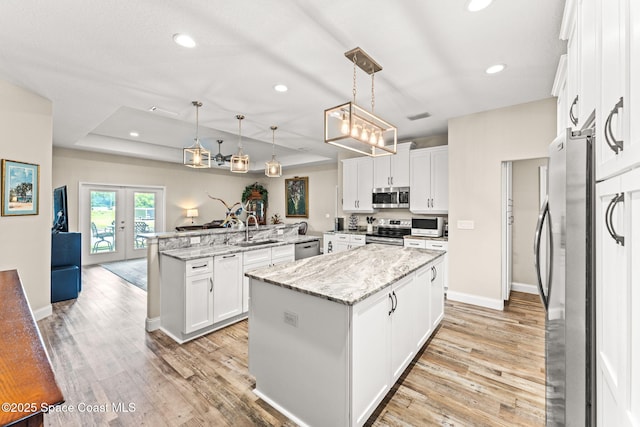 6435 Dixie Way, Mims, FL 32754 - kitchen featuring stainless steel appliances, a sink, a center island, light wood-type flooring, and recessed lighting