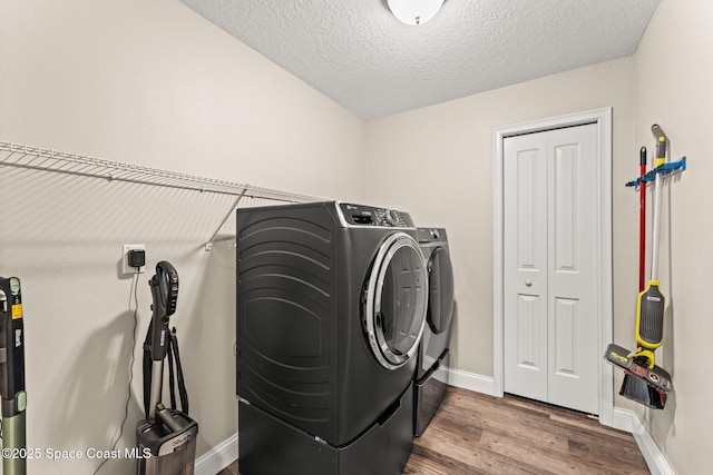 6435 Dixie Way, Mims, FL 32754 - washroom with washing machine and clothes dryer, wood finished floors, baseboards, and a textured ceiling