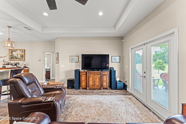 6435 Dixie Way, Mims, FL 32754 - living room featuring french doors, wood finished floors, a tray ceiling, and recessed lighting