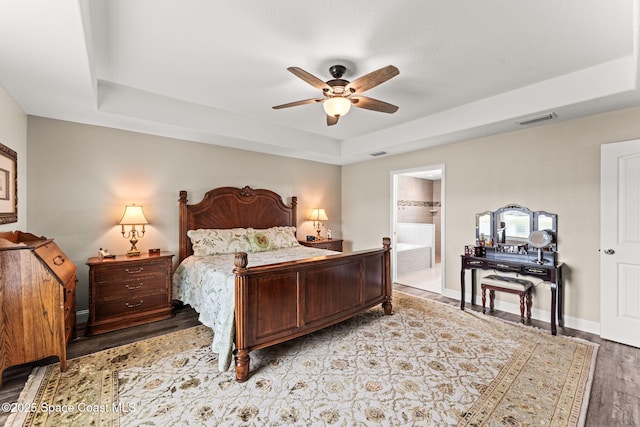 6435 Dixie Way, Mims, FL 32754 - bedroom featuring a raised ceiling, light wood-type flooring, connected bathroom, baseboards, and ceiling fan