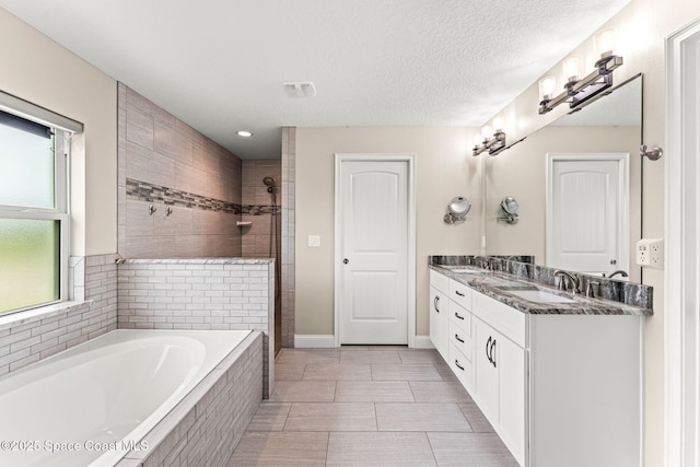 6435 Dixie Way, Mims, FL 32754 - full bathroom with double vanity, a garden tub, tiled shower, baseboards, and recessed lighting
