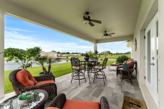 6435 Dixie Way, Mims, FL 32754 - view of patio / terrace featuring a water view, outdoor dining area, and ceiling fan