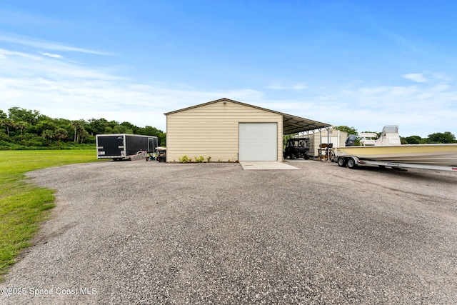 6435 Dixie Way, Mims, FL 32754 - garage featuring a detached garage and driveway