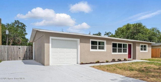 4415 Shaw Ave, Titusville, FL 32780 - ranch-style house featuring an attached garage, stucco siding, and concrete driveway