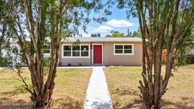 4415 Shaw Ave, Titusville, FL 32780 - view of front of house featuring a front lawn and stucco siding
