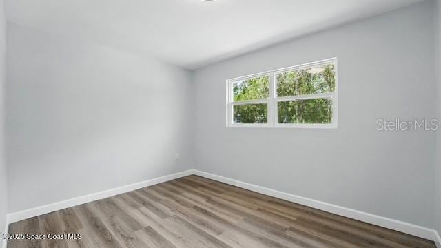 4415 Shaw Ave, Titusville, FL 32780 - unfurnished room with baseboards and wood finished floors