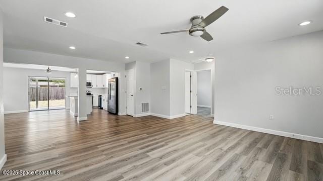 4415 Shaw Ave, Titusville, FL 32780 - unfurnished living room with a ceiling fan, baseboards, wood finished floors, and recessed lighting