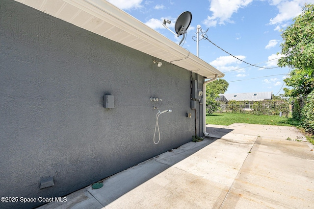 490 Candlestick Ave NE, Palm Bay, FL 32907 - view of home's exterior with stucco siding and a patio area