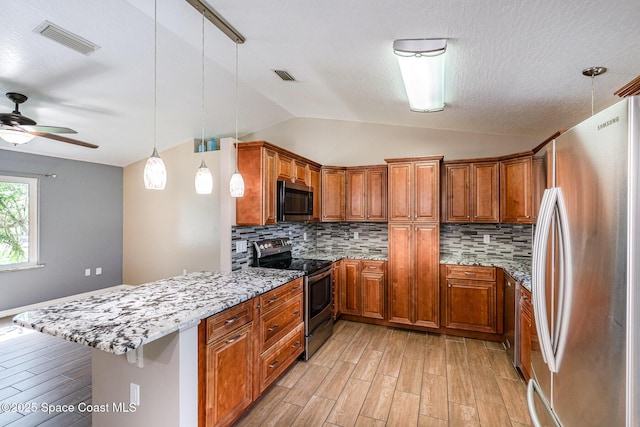 490 Candlestick Ave NE, Palm Bay, FL 32907 - kitchen featuring appliances with stainless steel finishes, a peninsula, brown cabinets, light wood-style floors, and lofted ceiling