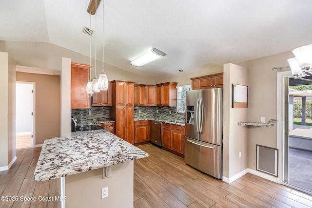 490 Candlestick Ave NE, Palm Bay, FL 32907 - kitchen with stainless steel refrigerator with ice dispenser, brown cabinetry, lofted ceiling, and light wood-style floors