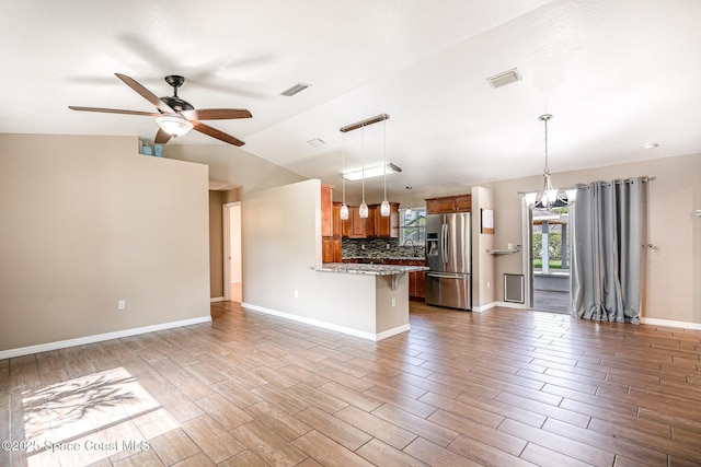 490 Candlestick Ave NE, Palm Bay, FL 32907 - kitchen with stainless steel refrigerator with ice dispenser, brown cabinetry, a ceiling fan, backsplash, and a peninsula