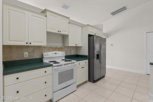 2829 SE Cabana Ln, Port St Lucie, FL 34952 - kitchen featuring stainless steel fridge, electric stove, dark countertops, and backsplash