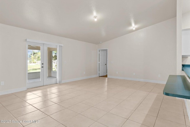 2829 SE Cabana Ln, Port St Lucie, FL 34952 - unfurnished room with french doors, light tile patterned floors, and baseboards