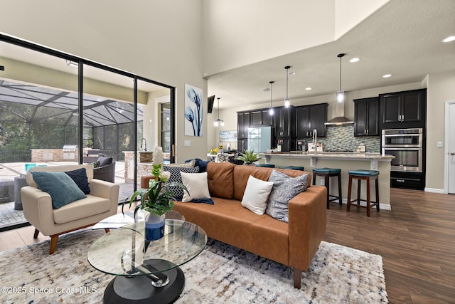 7914 Creshire Ct, Melbourne, FL 32940 - living area featuring a sunroom, dark wood-style flooring, and recessed lighting