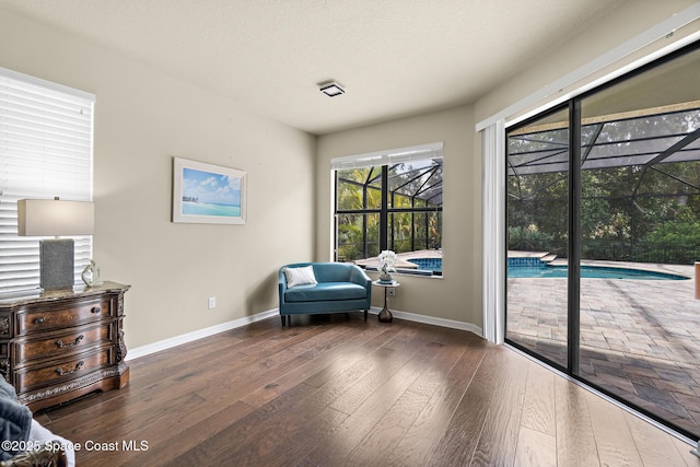 7914 Creshire Ct, Melbourne, FL 32940 - living area featuring hardwood / wood-style floors, a sunroom, and baseboards