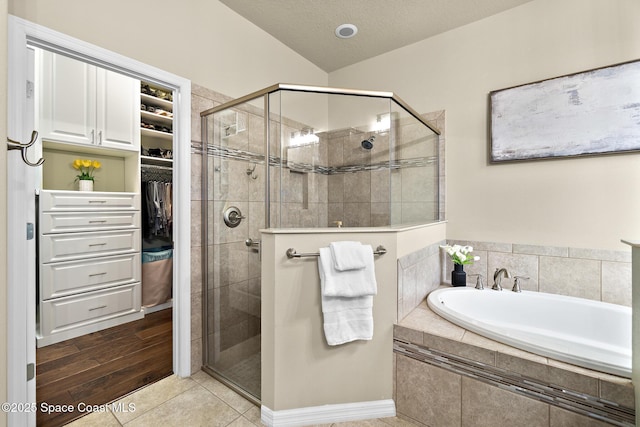 7914 Creshire Ct, Melbourne, FL 32940 - full bathroom featuring a garden tub, a stall shower, a spacious closet, tile patterned floors, and a textured ceiling