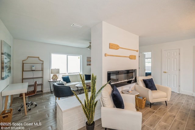 201 NE 3rd St, Satellite Beach, FL 32937 - living area with wood finish floors, healthy amount of natural light, ceiling fan, and baseboards