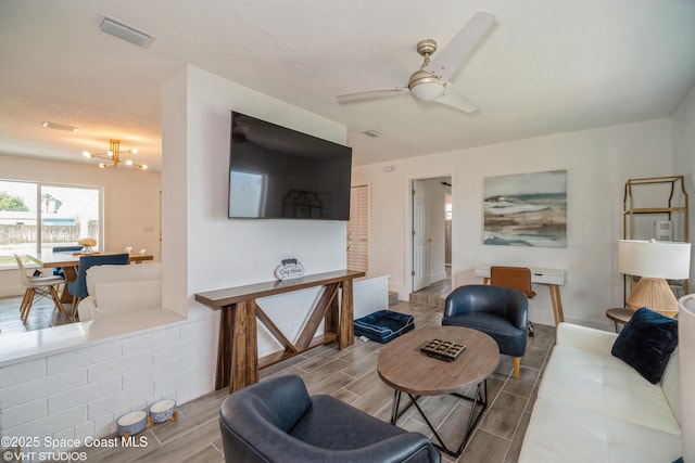 201 NE 3rd St, Satellite Beach, FL 32937 - living room featuring a chandelier, wood finish floors, and a ceiling fan