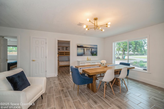 201 NE 3rd St, Satellite Beach, FL 32937 - dining area featuring a chandelier, baseboards, and wood tiled floors