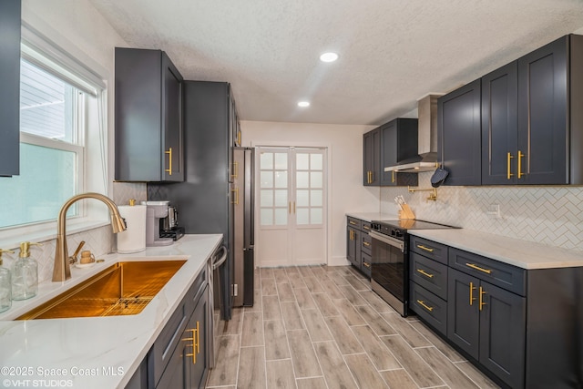 201 NE 3rd St, Satellite Beach, FL 32937 - kitchen with electric stove, a sink, wall chimney exhaust hood, backsplash, and a textured ceiling