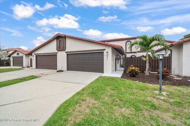 977 Osprey Dr, Melbourne, FL 32940 - mediterranean / spanish-style home with an attached garage, stucco siding, concrete driveway, a tiled roof, and a gate