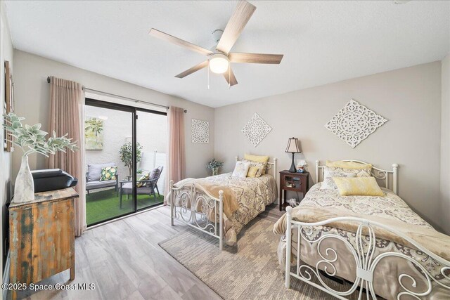 977 Osprey Dr, Melbourne, FL 32940 - bedroom featuring access to exterior, wood finished floors, and ceiling fan