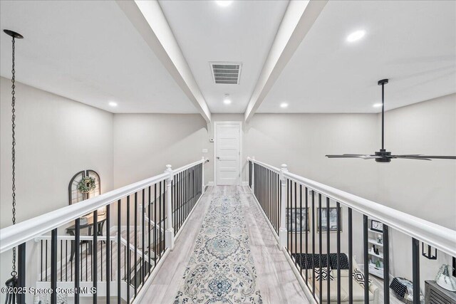 977 Osprey Dr, Melbourne, FL 32940 - hall with recessed lighting, wood finished floors, and an upstairs landing