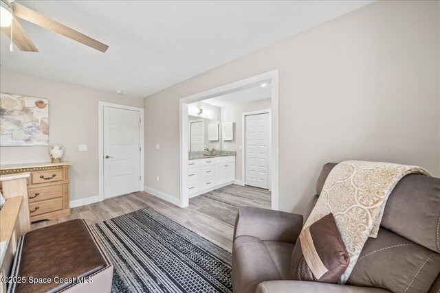 977 Osprey Dr, Melbourne, FL 32940 - living area with light wood-style floors, ceiling fan, and baseboards