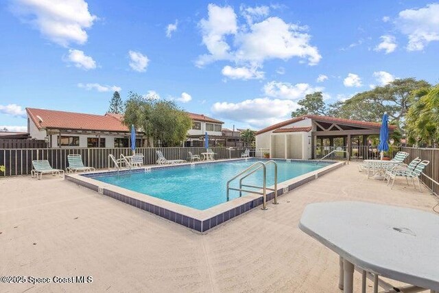 977 Osprey Dr, Melbourne, FL 32940 - community pool featuring a patio